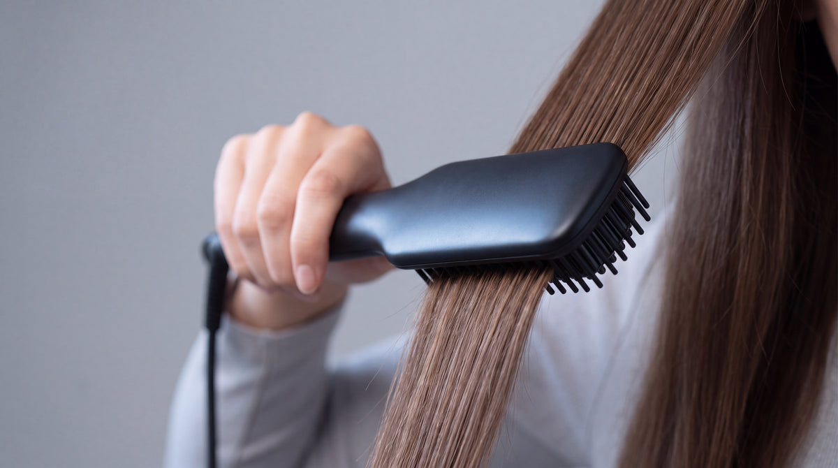 Mujer usando un cepillo alisador eléctrico para dejar el cabello liso y brillante, categoría Cepillos de BRILLABONITA™